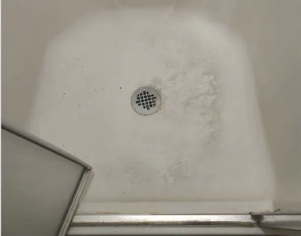Shower floor before deep cleaning